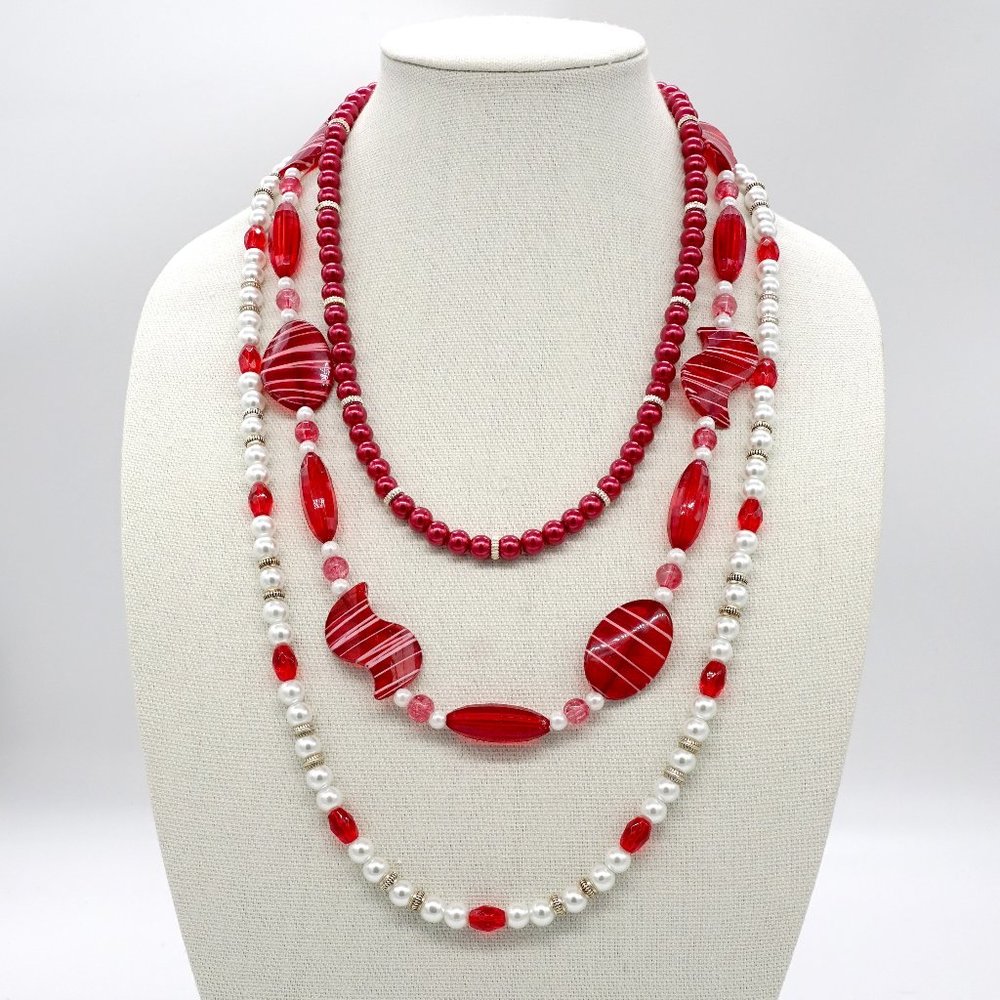 Three strand red and white necklace.
